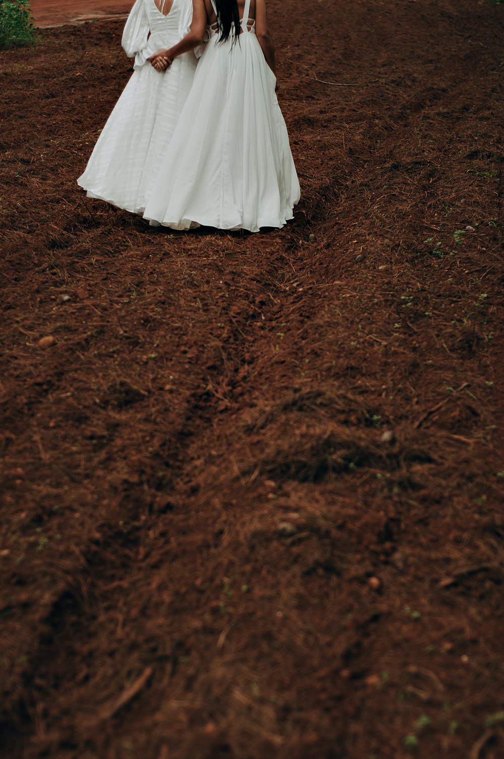 a couple of people that are standing in the dirt