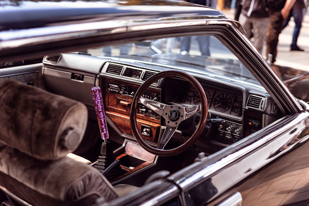 the interior of a car with a steering wheel and dashboard