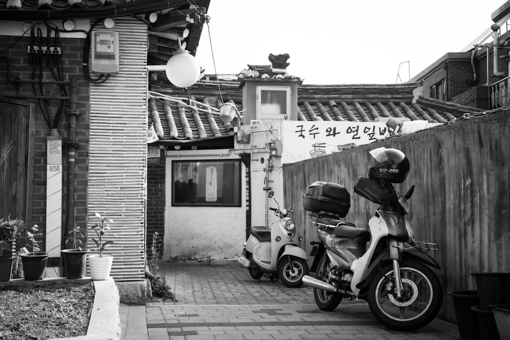 a motor scooter is parked in front of a building