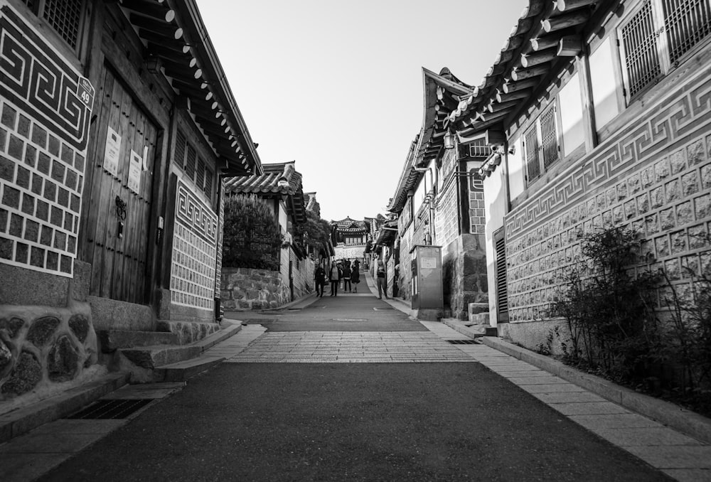 a black and white photo of a narrow street