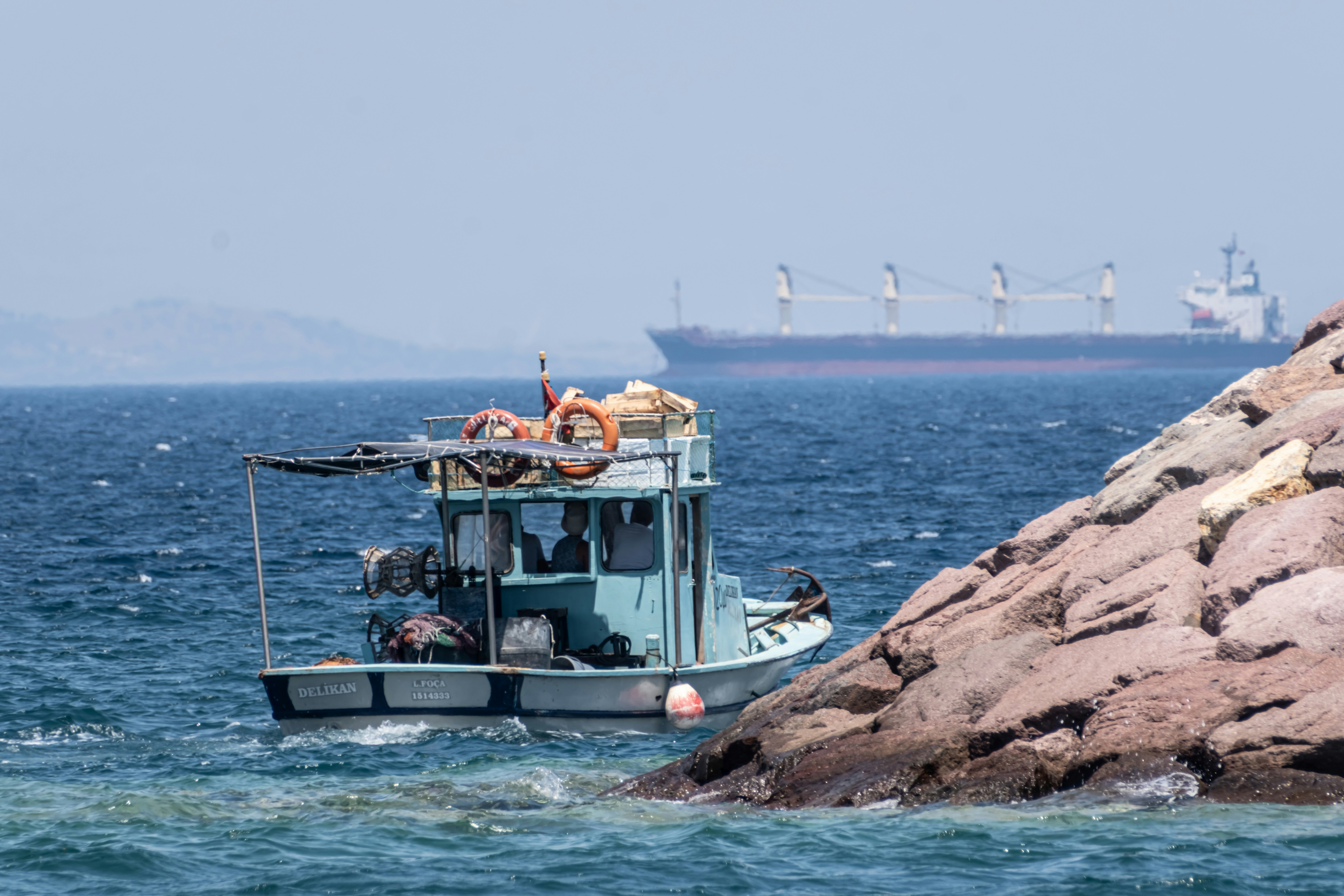 a small boat in the middle of the ocean