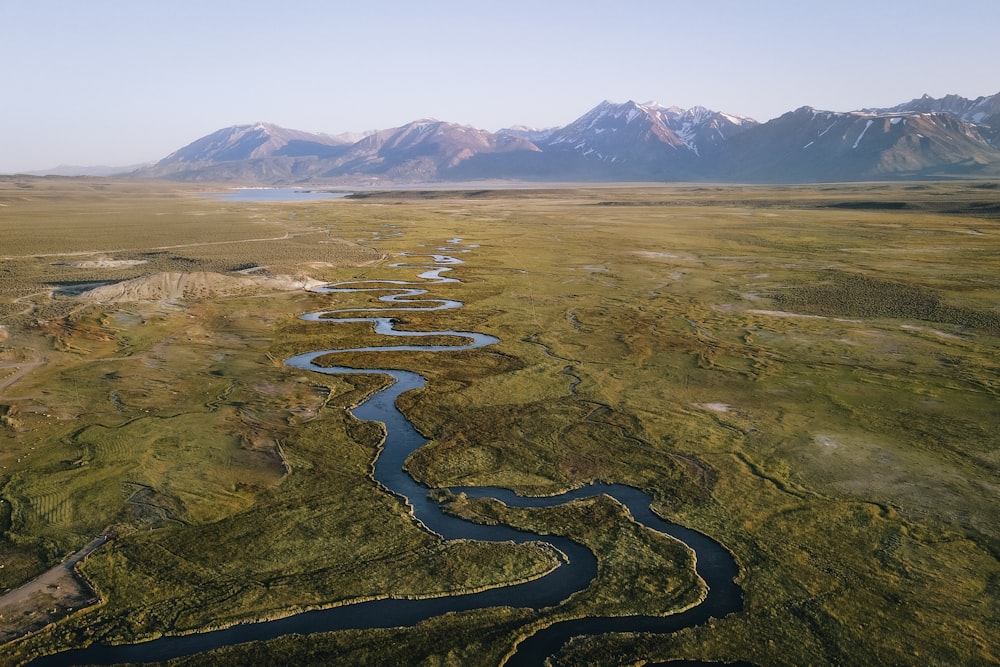 an aerial view of a river and mountains