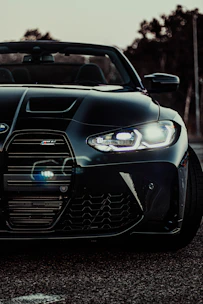 Close-up shot of a sleek supercar's aggressive front grille under moody lighting.