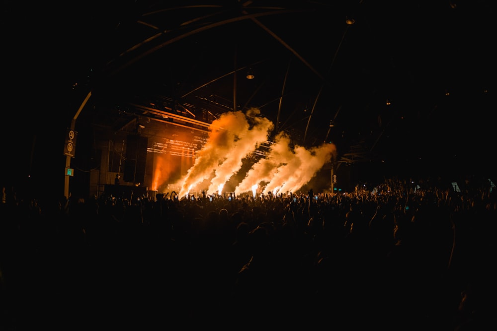 a large group of people standing around a stage