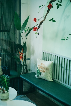 A cozy corner with plants and floral decorations creating a relaxing ambiance.