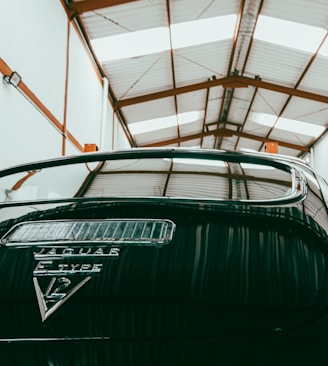 a car parked inside of a garage next to another car