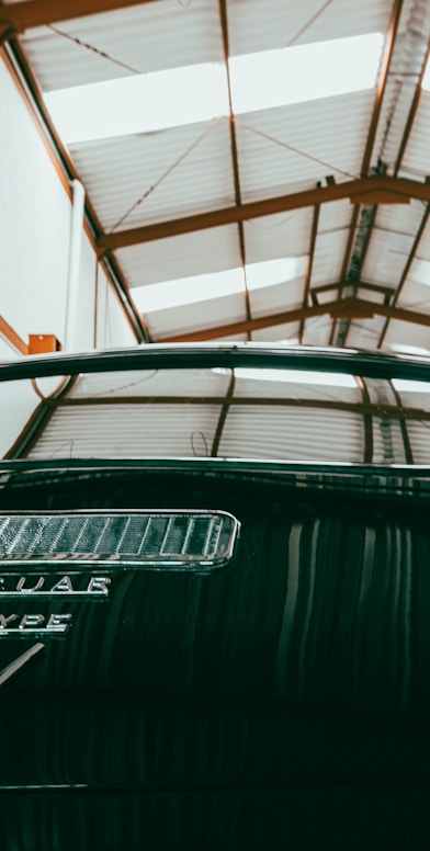 a car parked inside of a garage next to another car