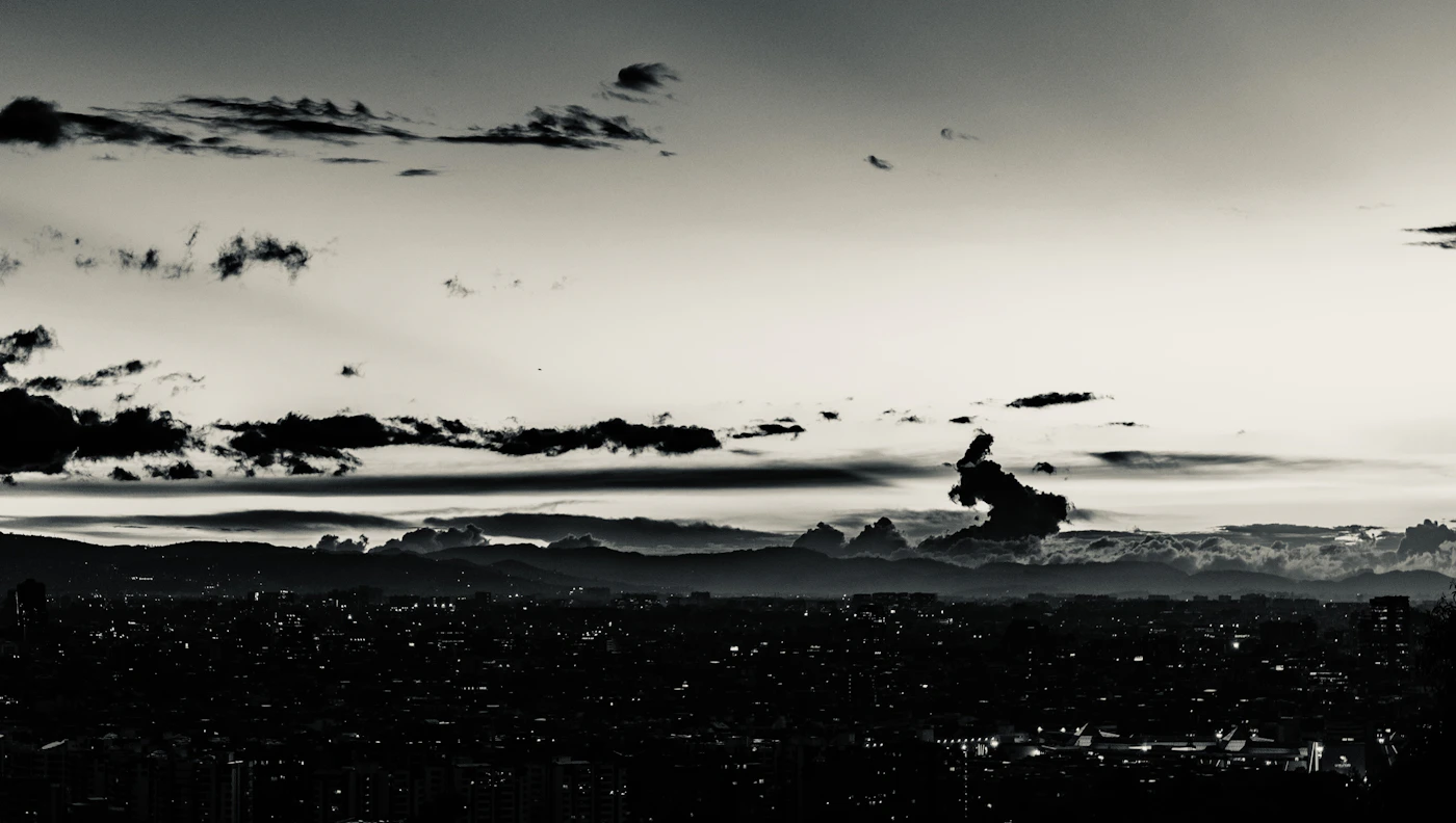 Bogotá's La Candelaria neighbourhood in black and white, colonial rooftops receding toward the mountains