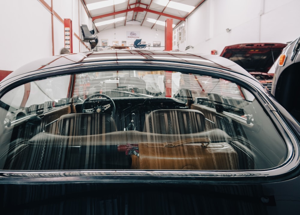 an old car is parked in a garage