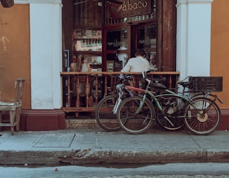 A cozy corner of the hotel lobby with bikes parked neatly and guests chatting.