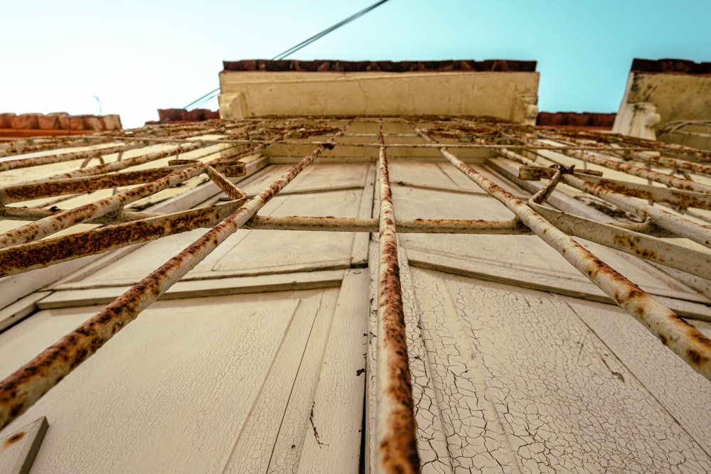 a close up of a building with rusted metal bars