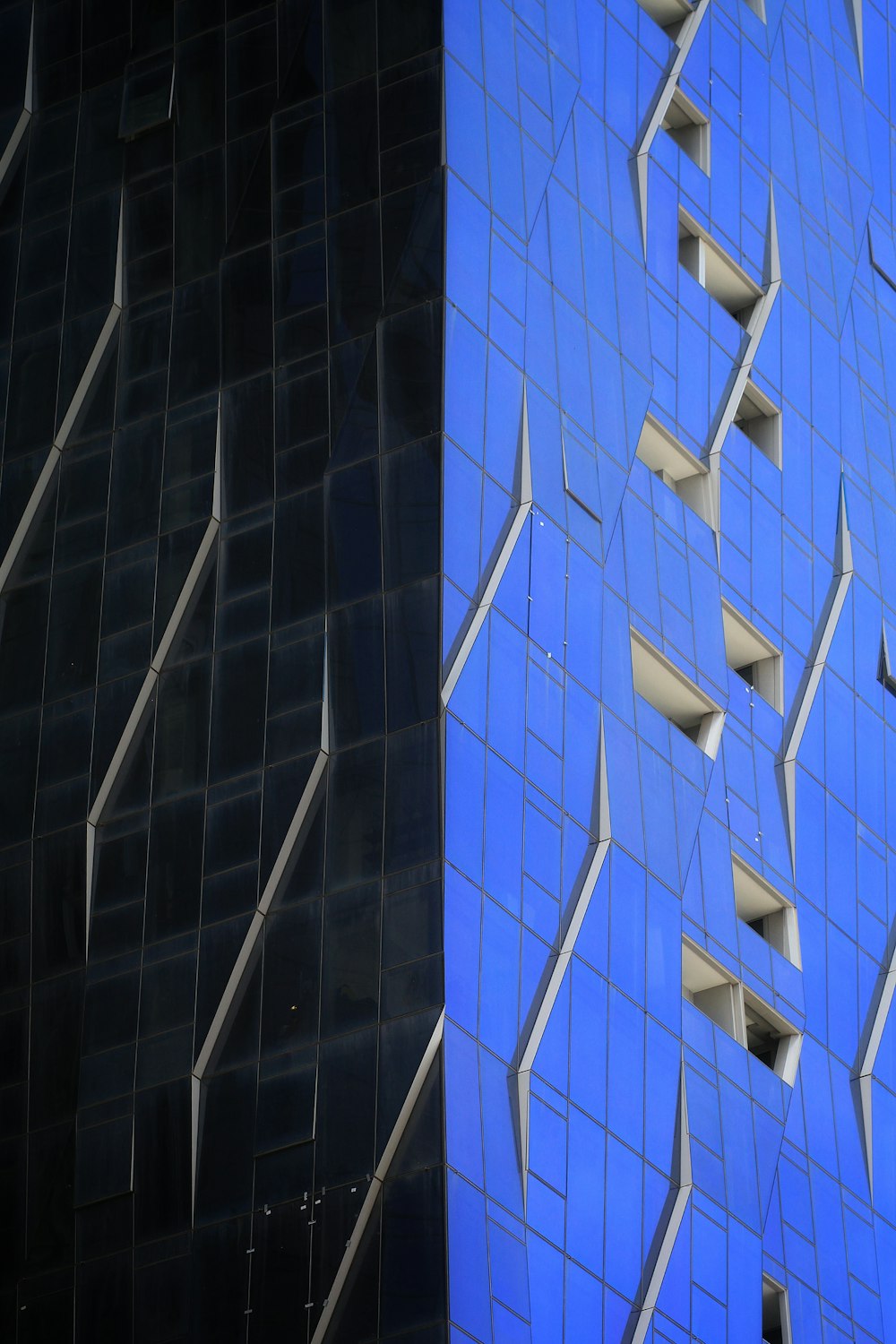 a very tall building with a blue facade