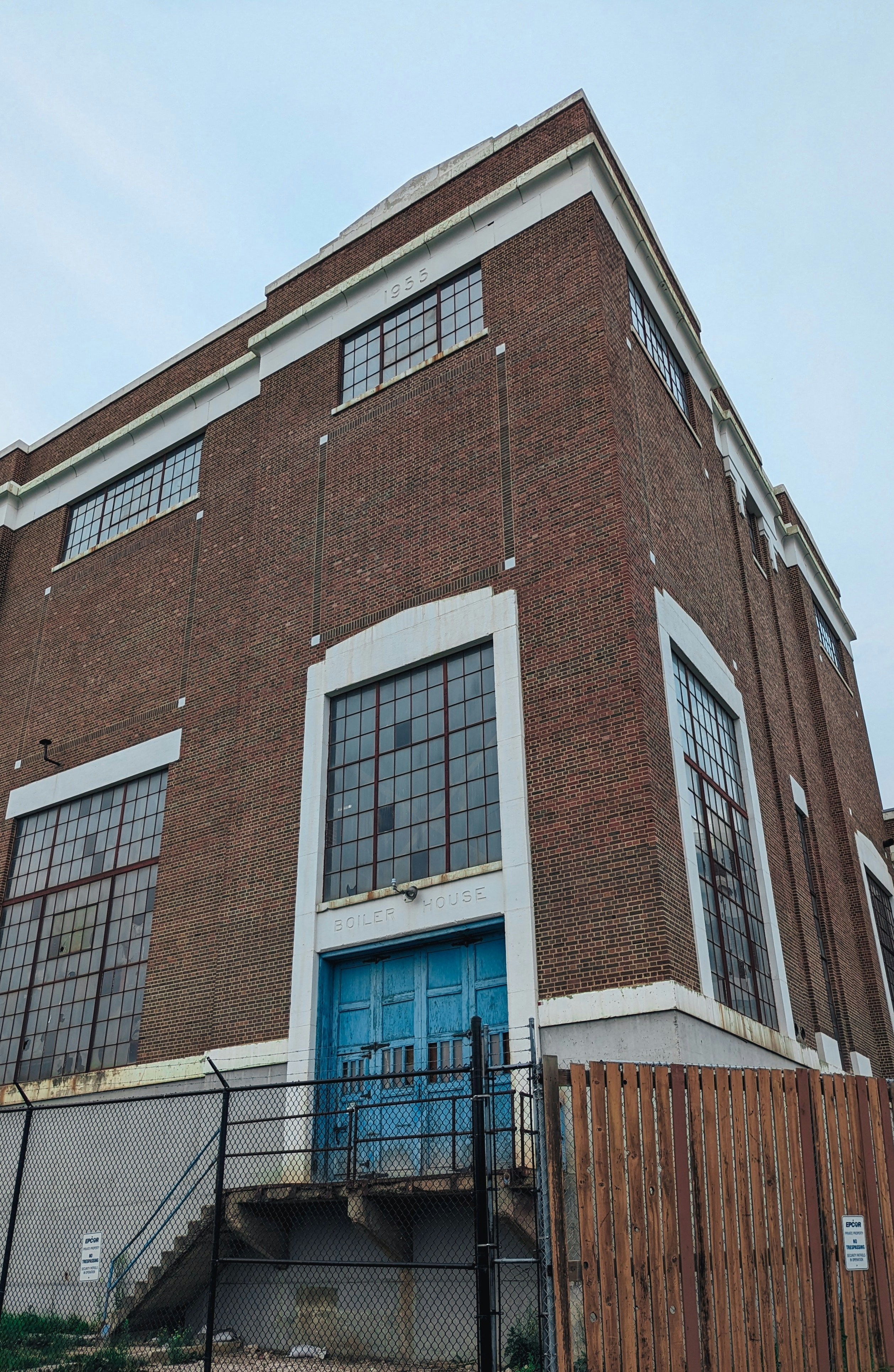 a tall brick building with a blue door