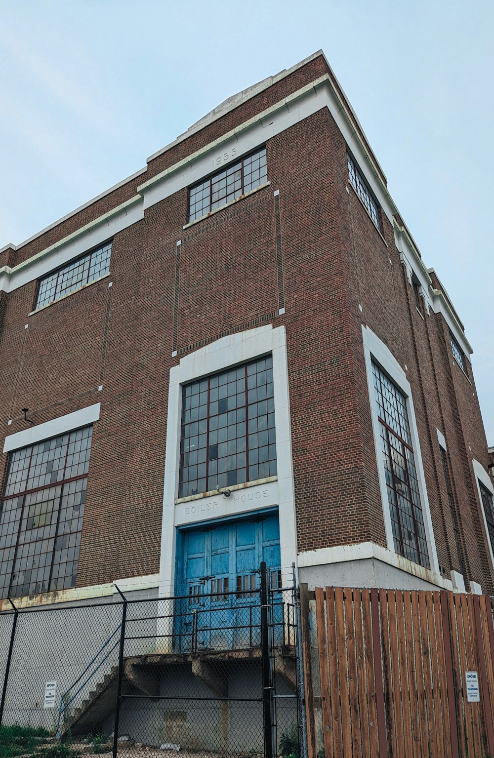 a tall brick building with a blue door