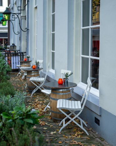 A cozy outdoor café in Paris with golden light filtering through autumn leaves.