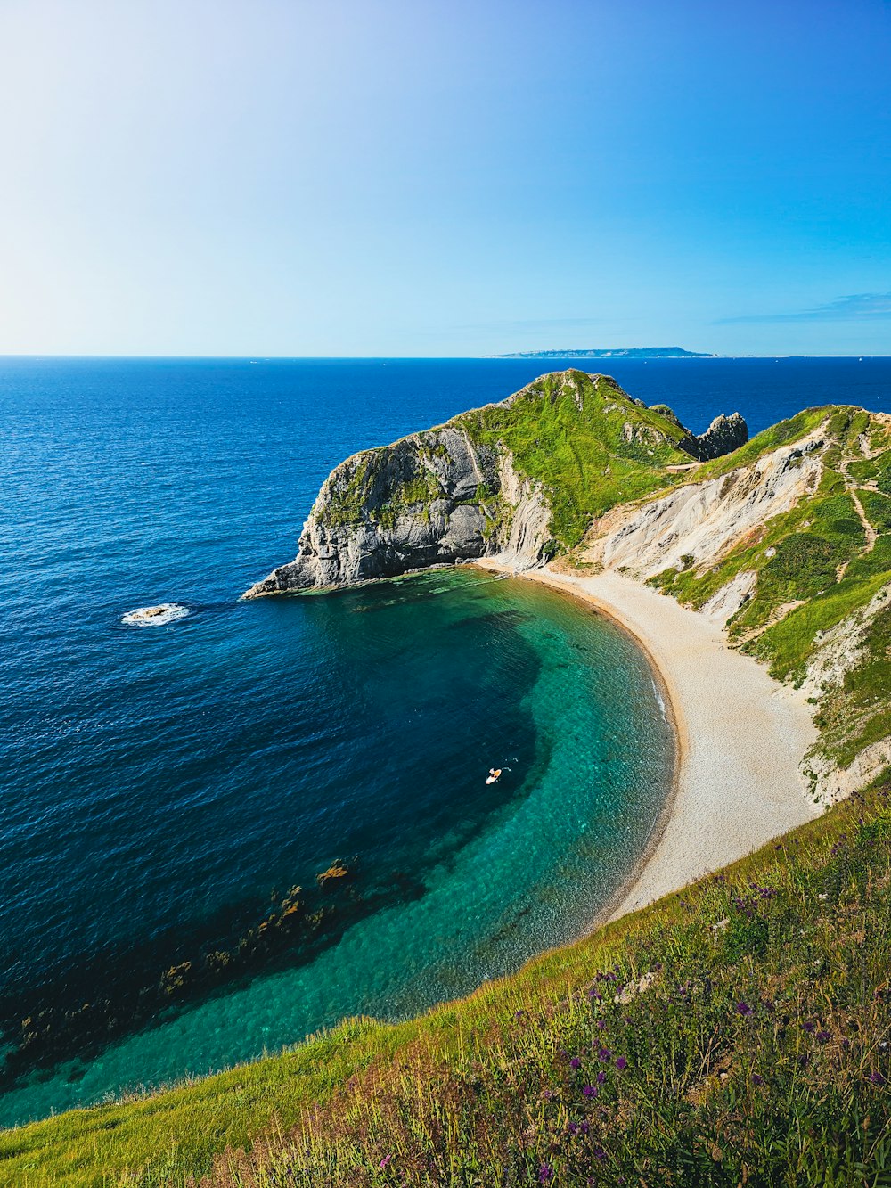 a sandy beach on the edge of a cliff