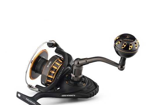 A high-quality fishing reel with a sleek black and gold design. It features a sturdy handle and a spool labeled 'BG 5000'. The construction is robust, indicating durability, with a smooth and ergonomic design suitable for comfortable use.