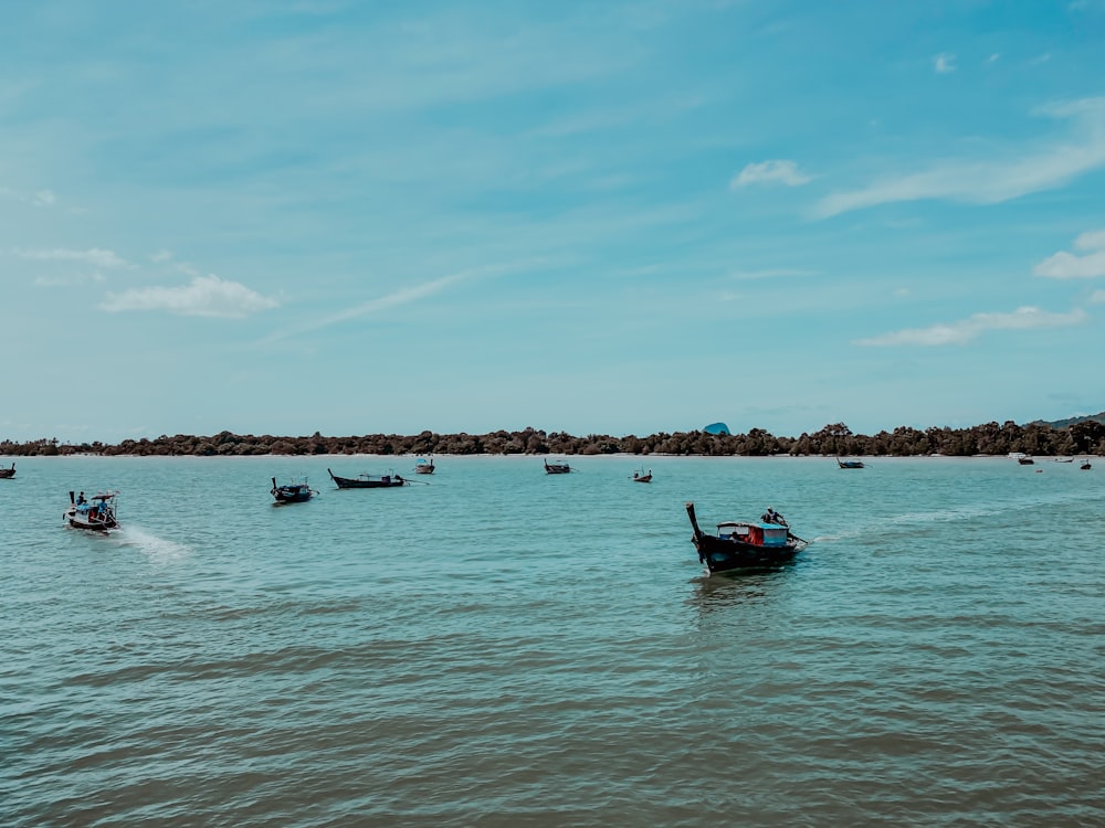 a number of small boats in a large body of water