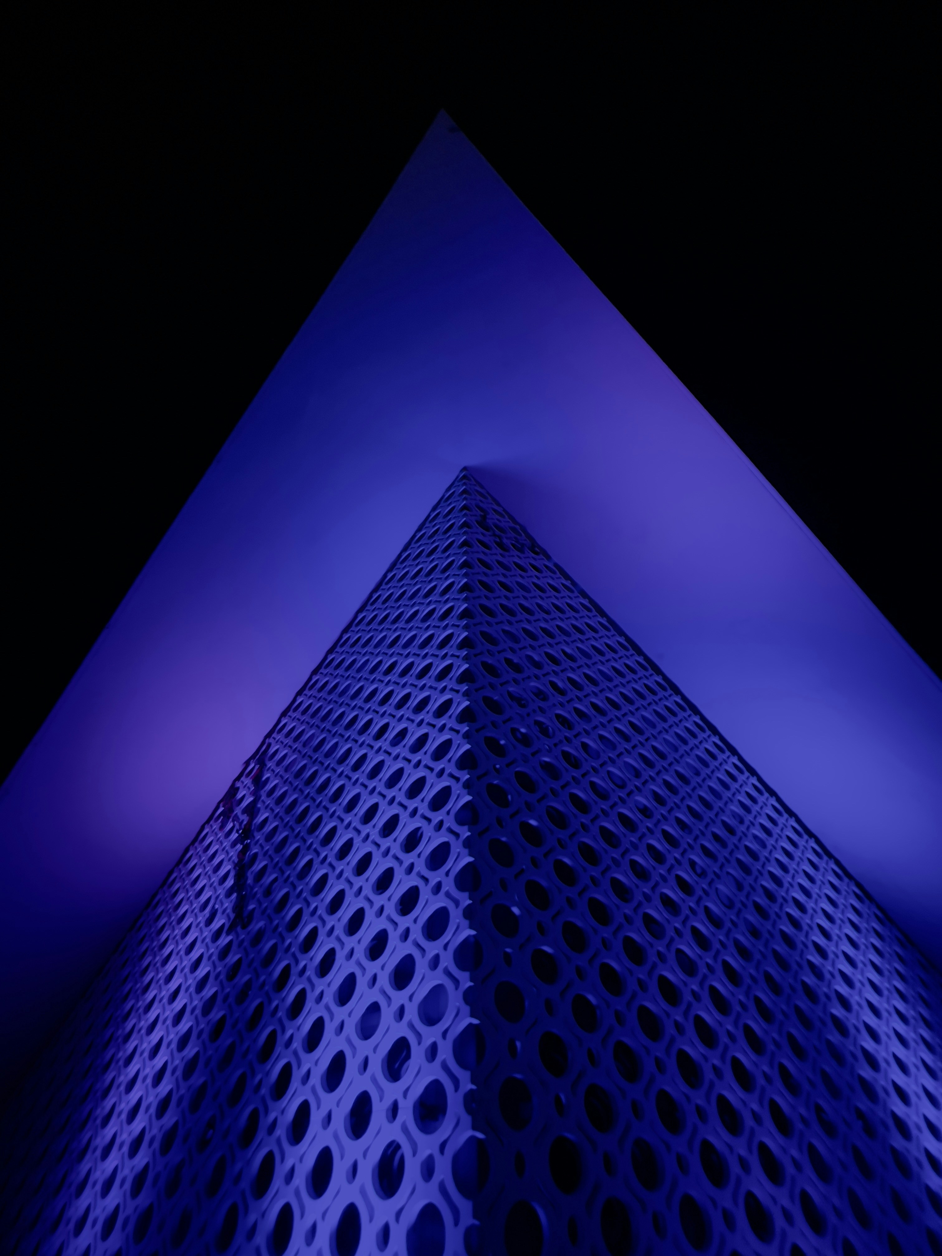 a tall building with a lot of holes on it