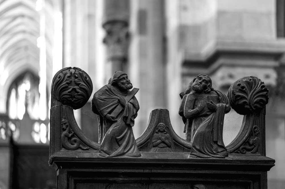 a black and white photo of a statue in a church