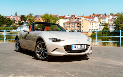 Sporty Mazda roadster with the top down on a sunny day.