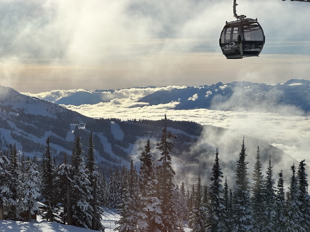 a ski lift going up a snowy mountain