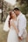 A serene outdoor pre-wedding shoot with a couple embracing in a picturesque landscape.