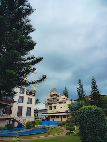 A serene temple entrance surrounded by greenery under a clear sky.