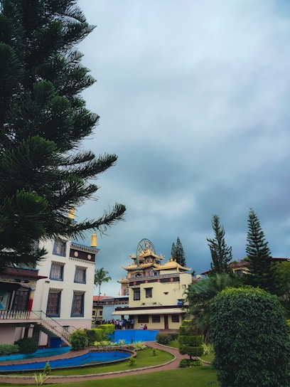 A serene view of Shri Mookambika Temple Guest House surrounded by nature.