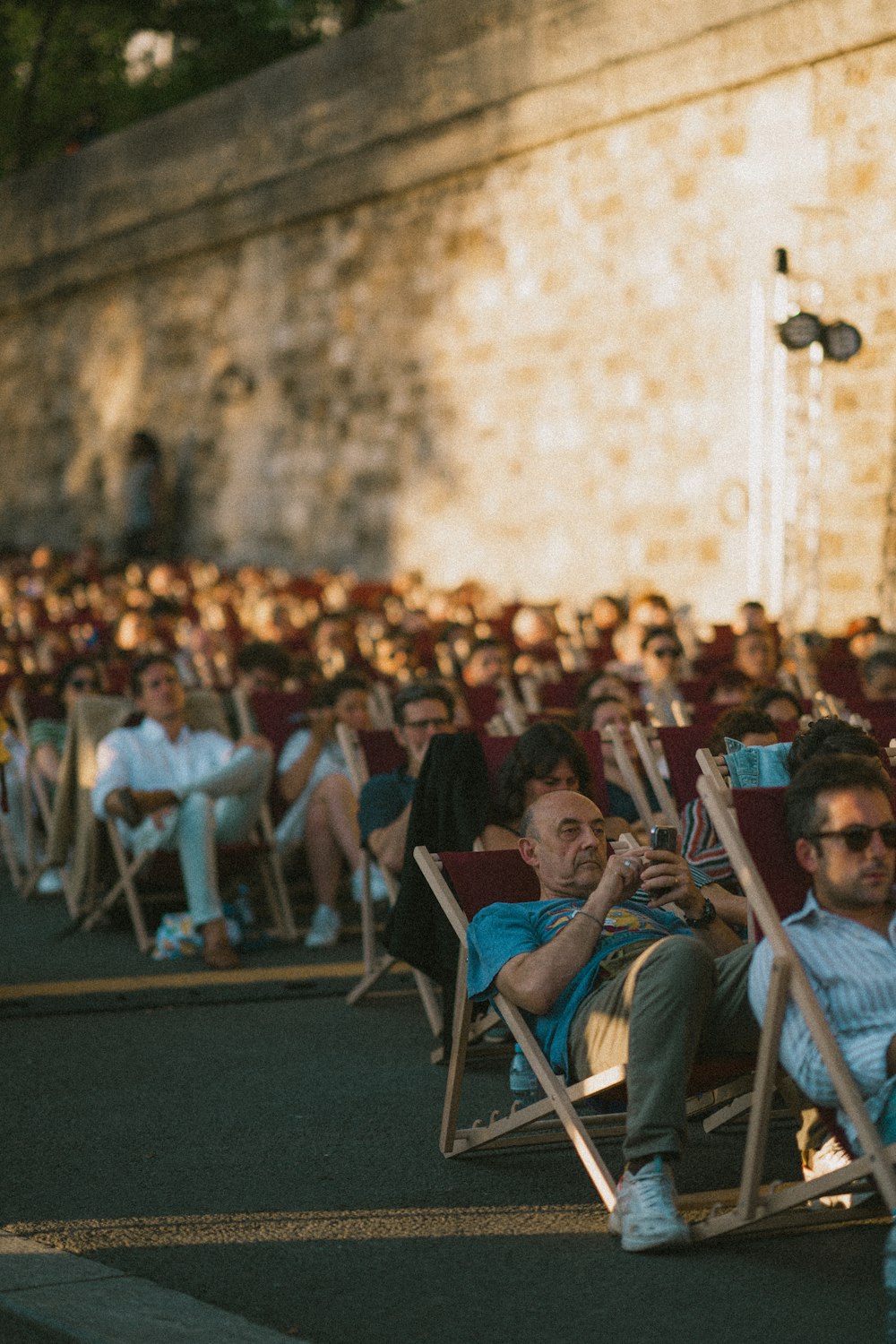 a group of people sitting in lawn chairs