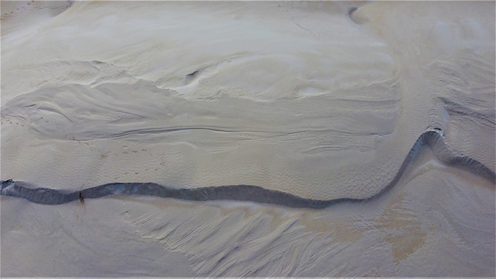 an aerial view of a river in the sand