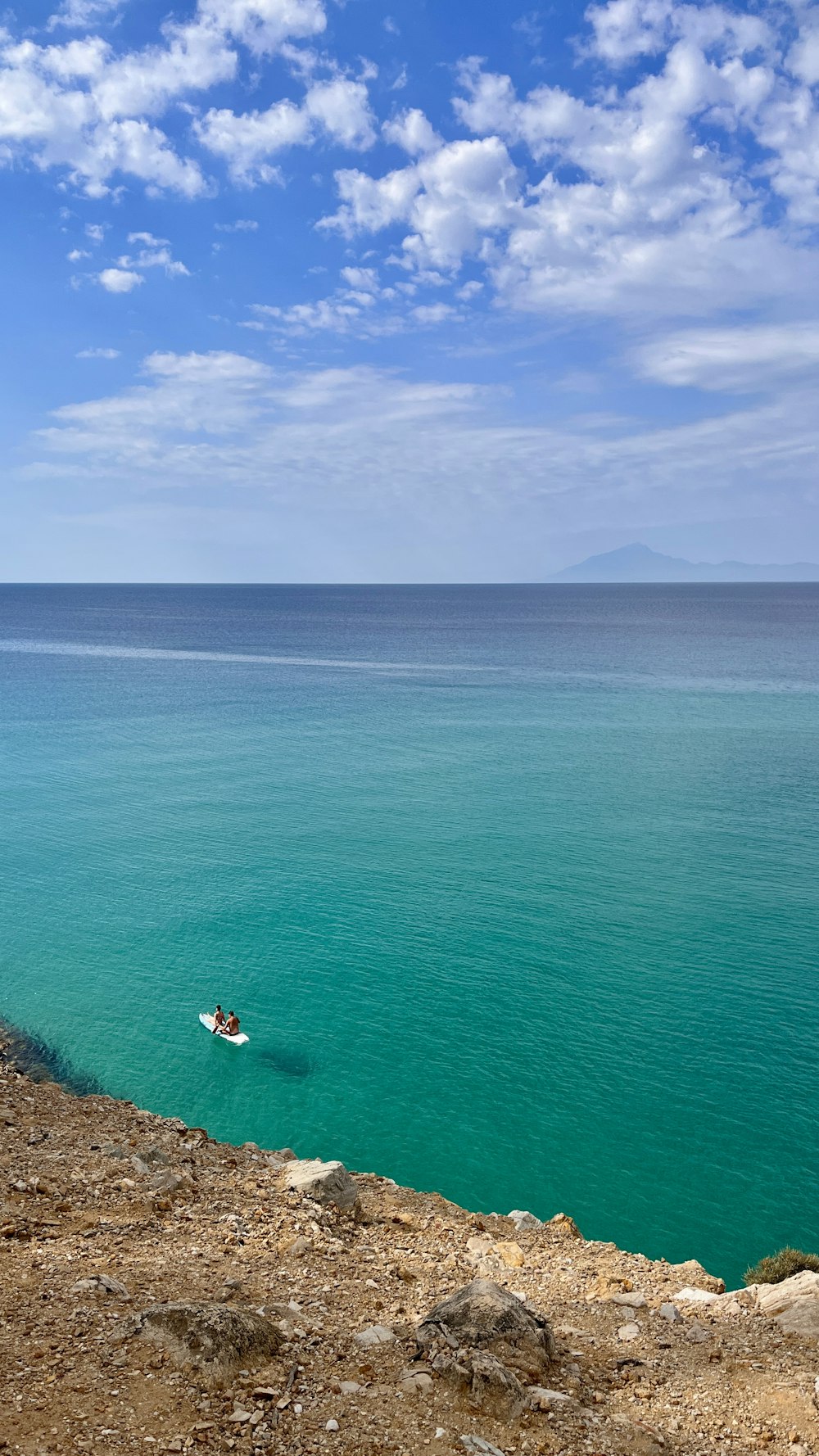 a person on a surfboard in the middle of the ocean