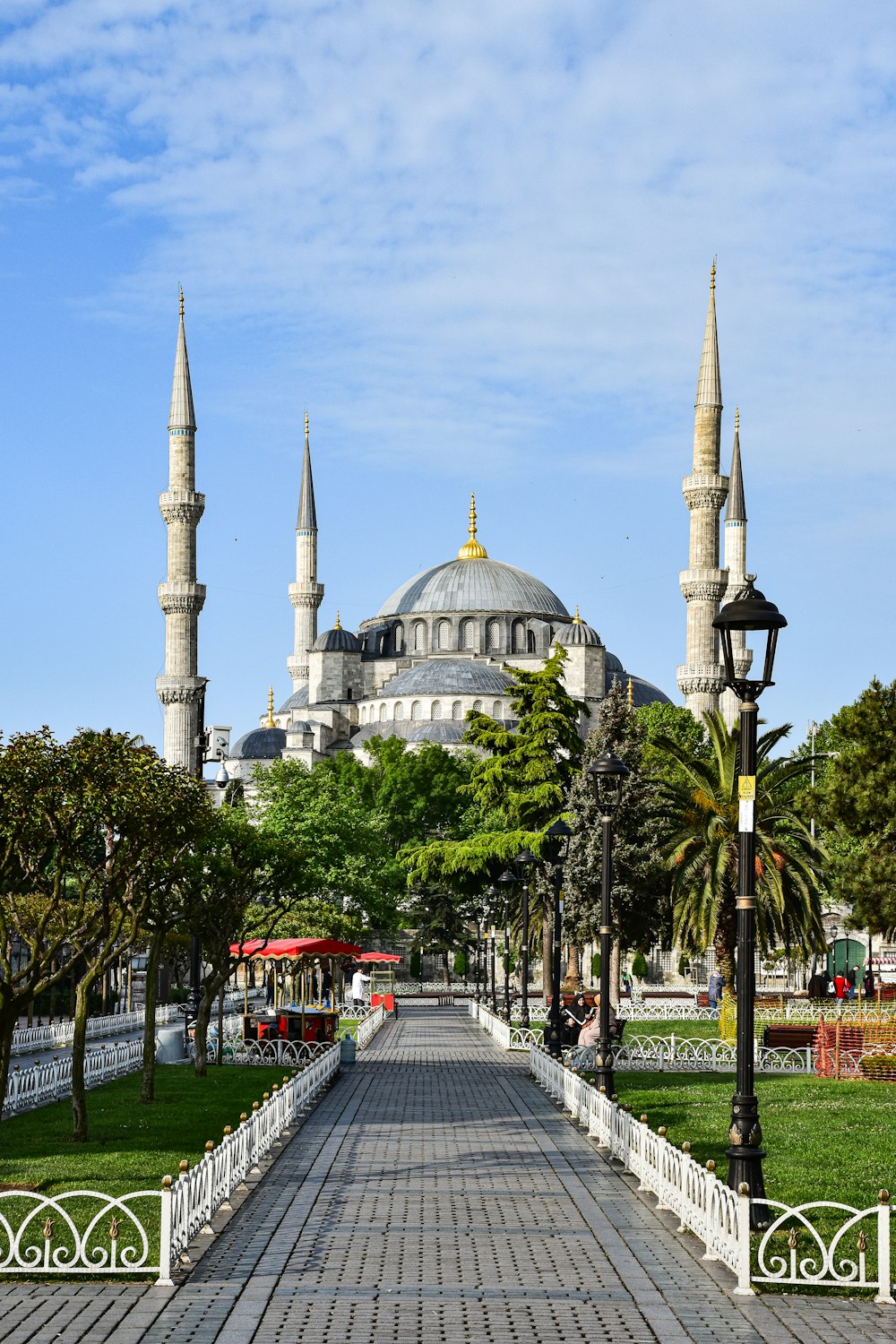 a walkway leading to a large white building