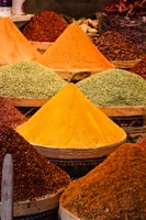 Colorful spices arranged in neat piles showcasing their rich textures.