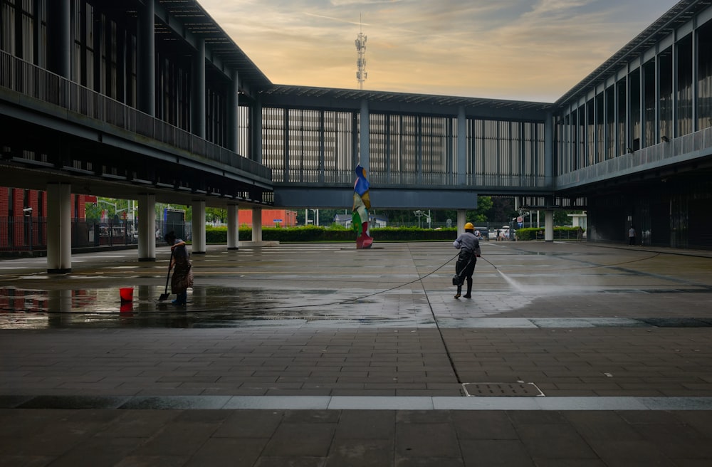 a person with a hose in a parking lot