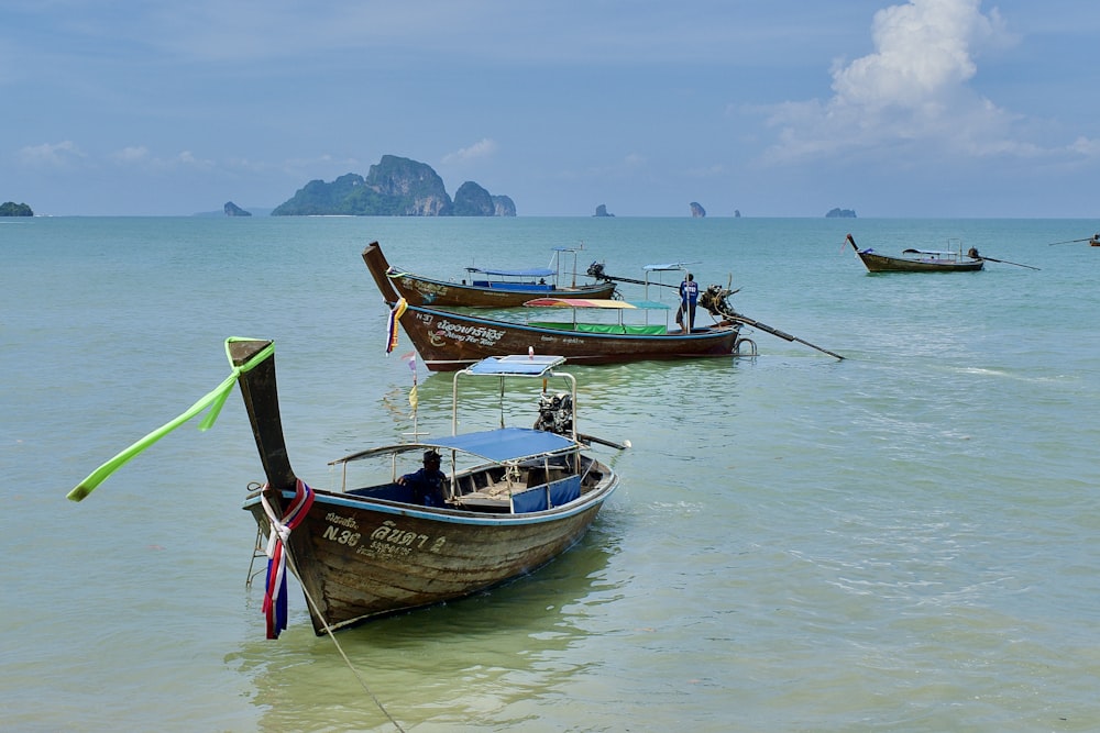 a group of boats floating on top of a body of water