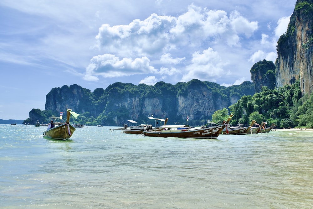 a group of boats floating on top of a body of water