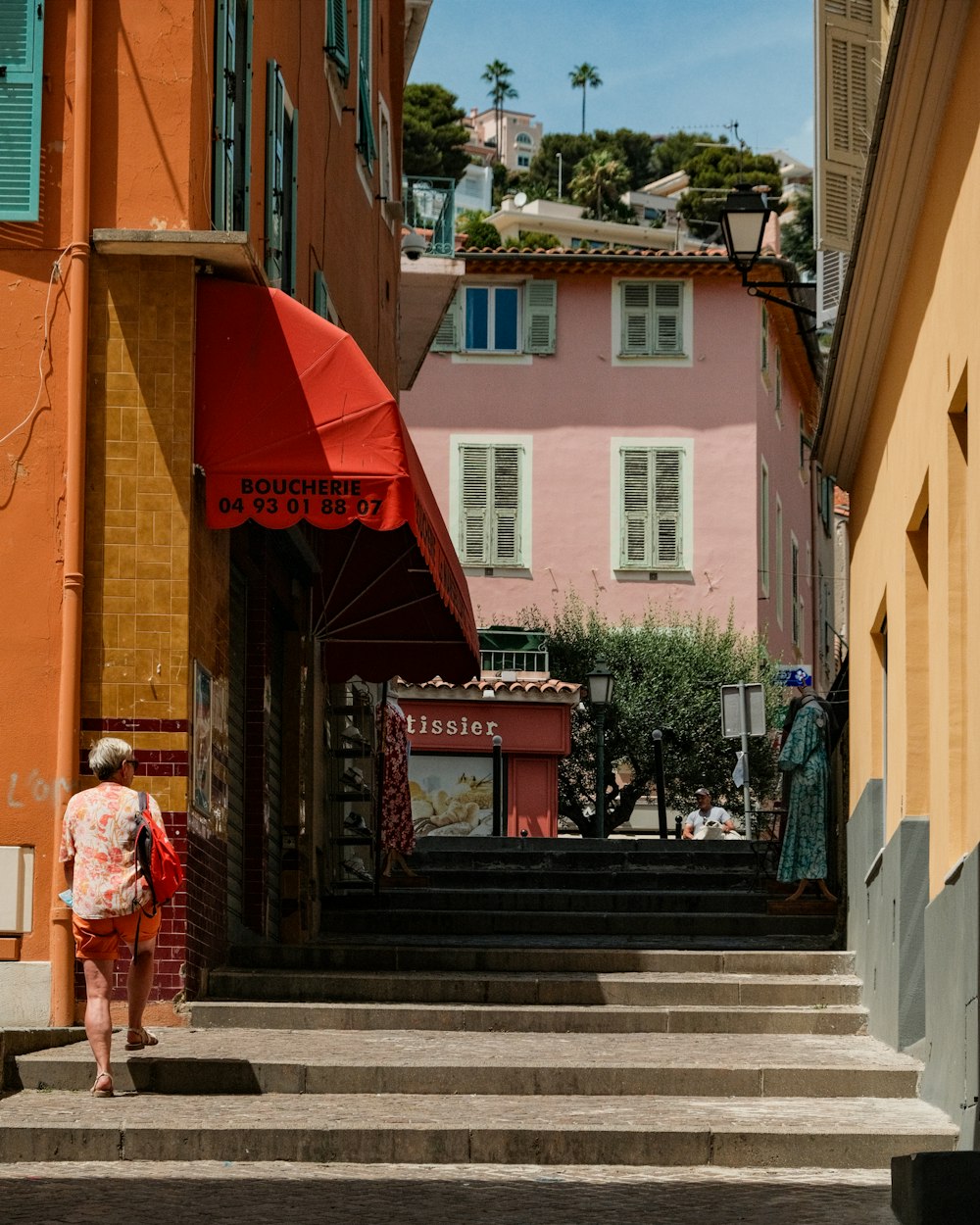 a woman walking up some steps in front of a building