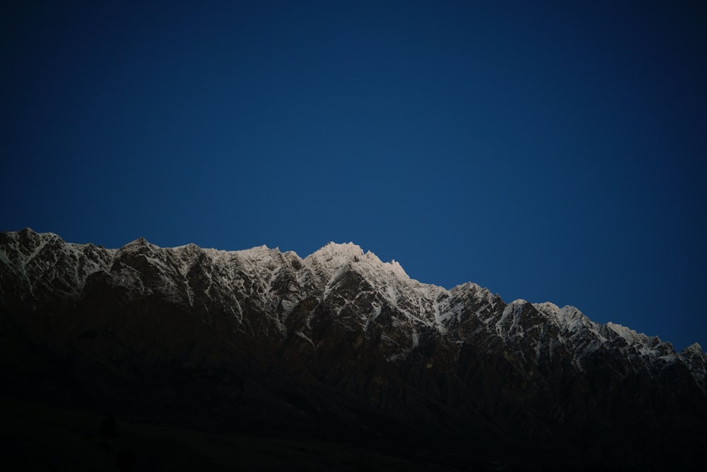 a view of the top of a snow covered mountain