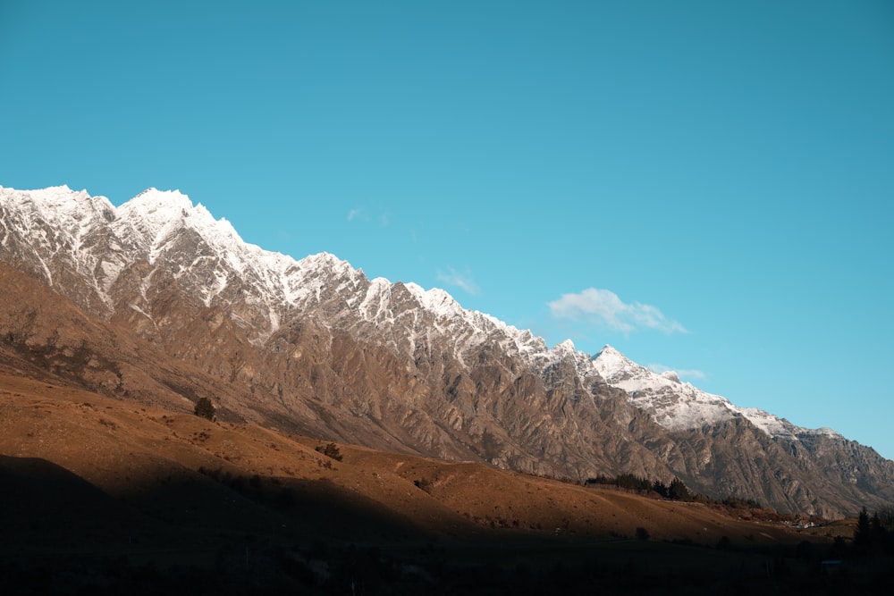 a view of a mountain range with snow on the top