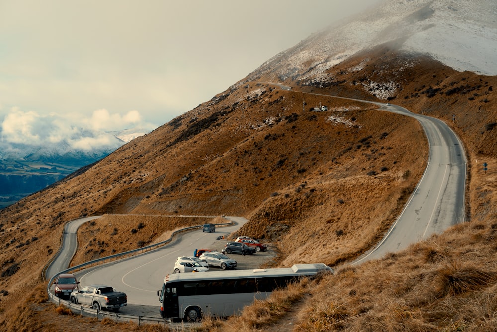 a bus driving down a winding mountain road