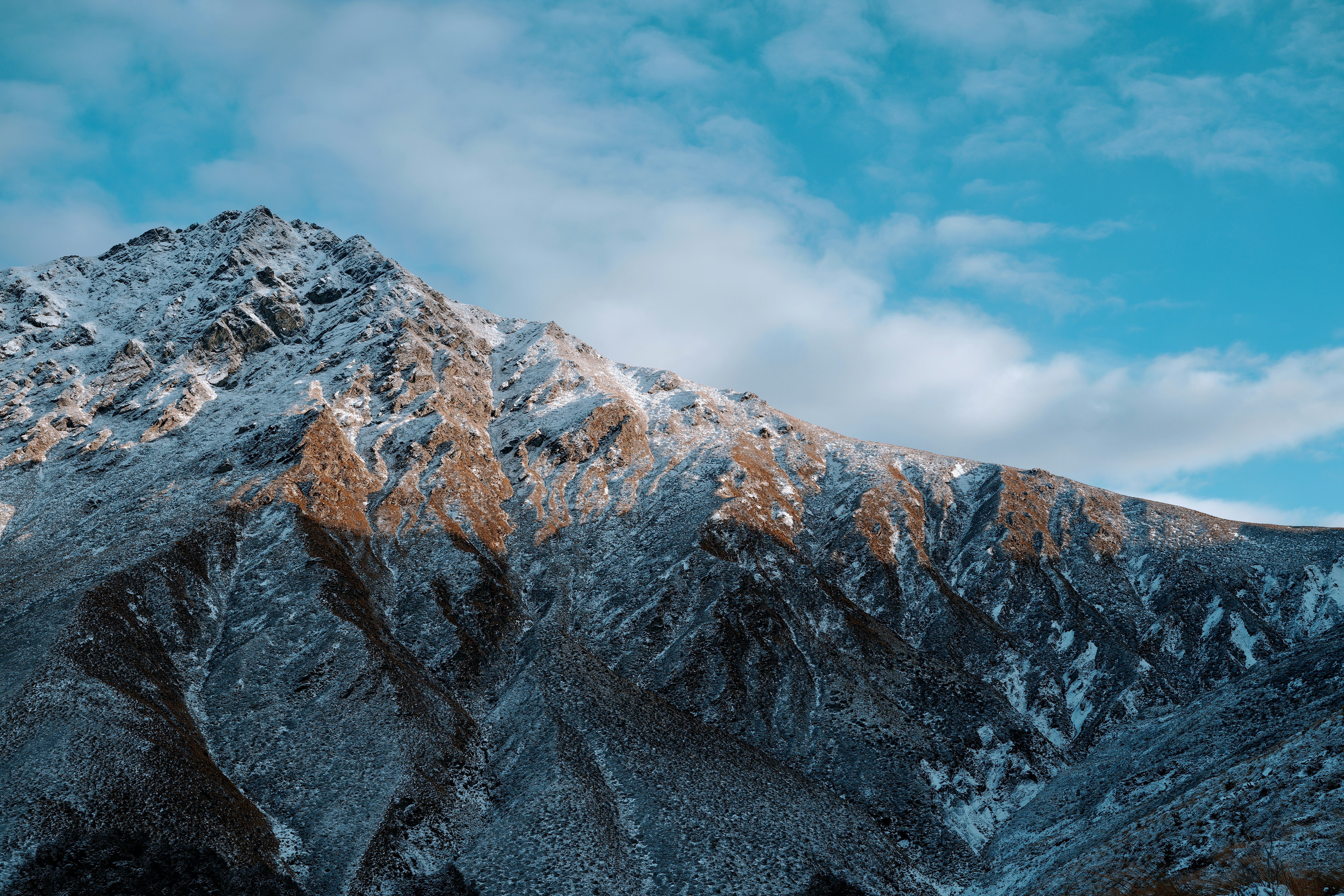 a snow covered mountain with a blue sky in the background