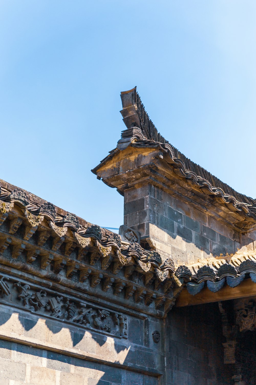 a bird is perched on the roof of a building