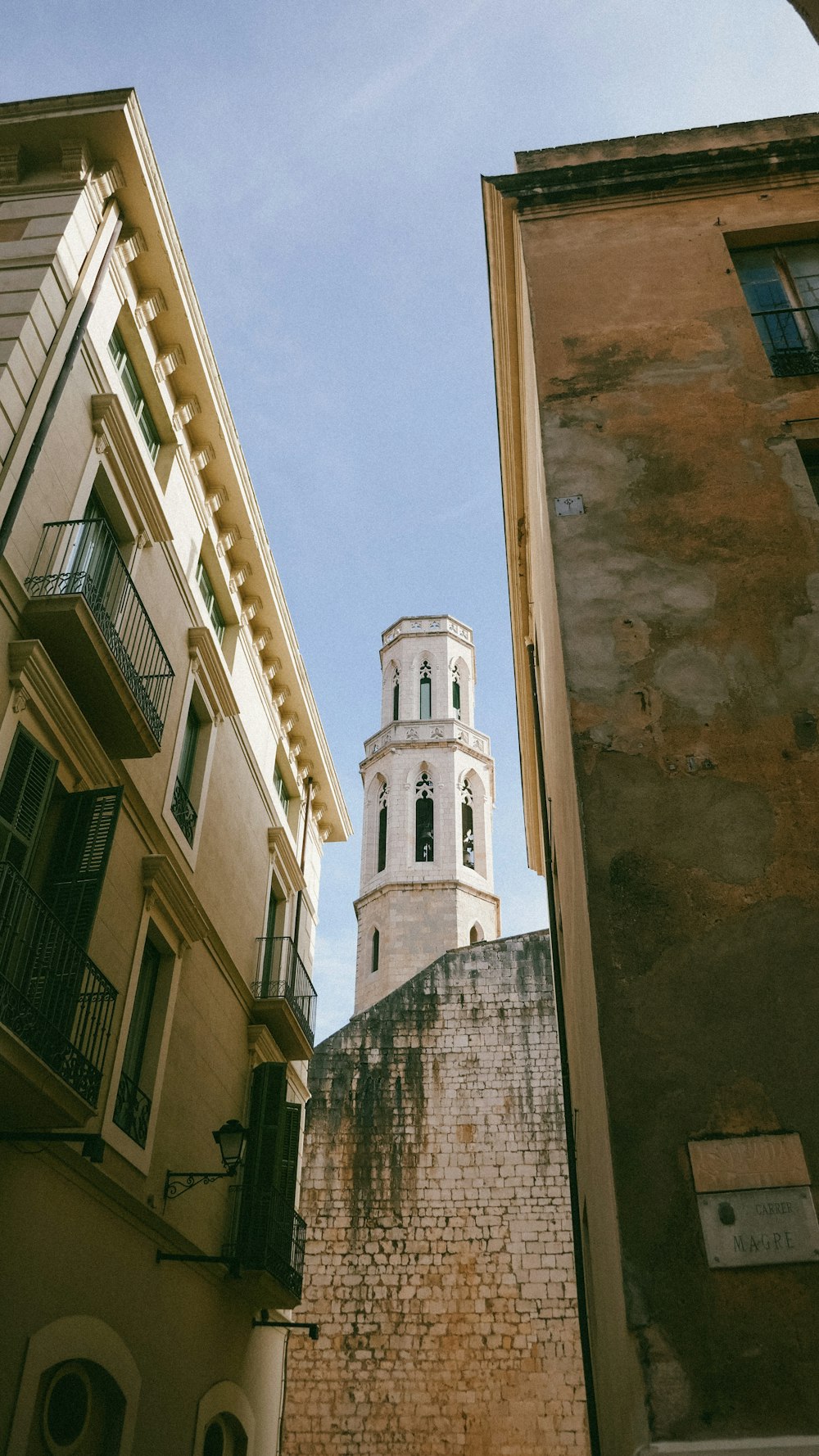 a tall white clock tower towering over a city