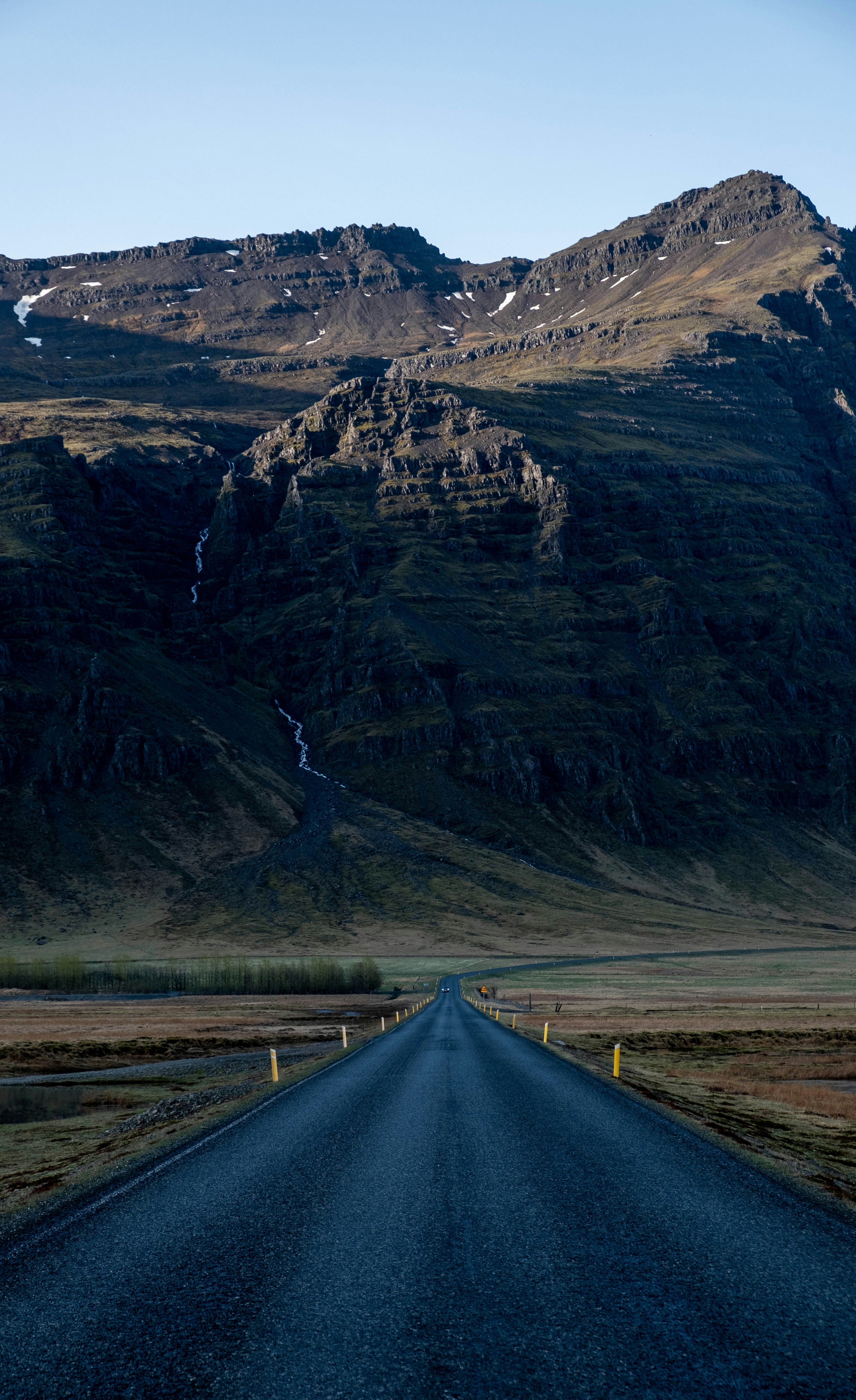 a long road with a mountain in the background