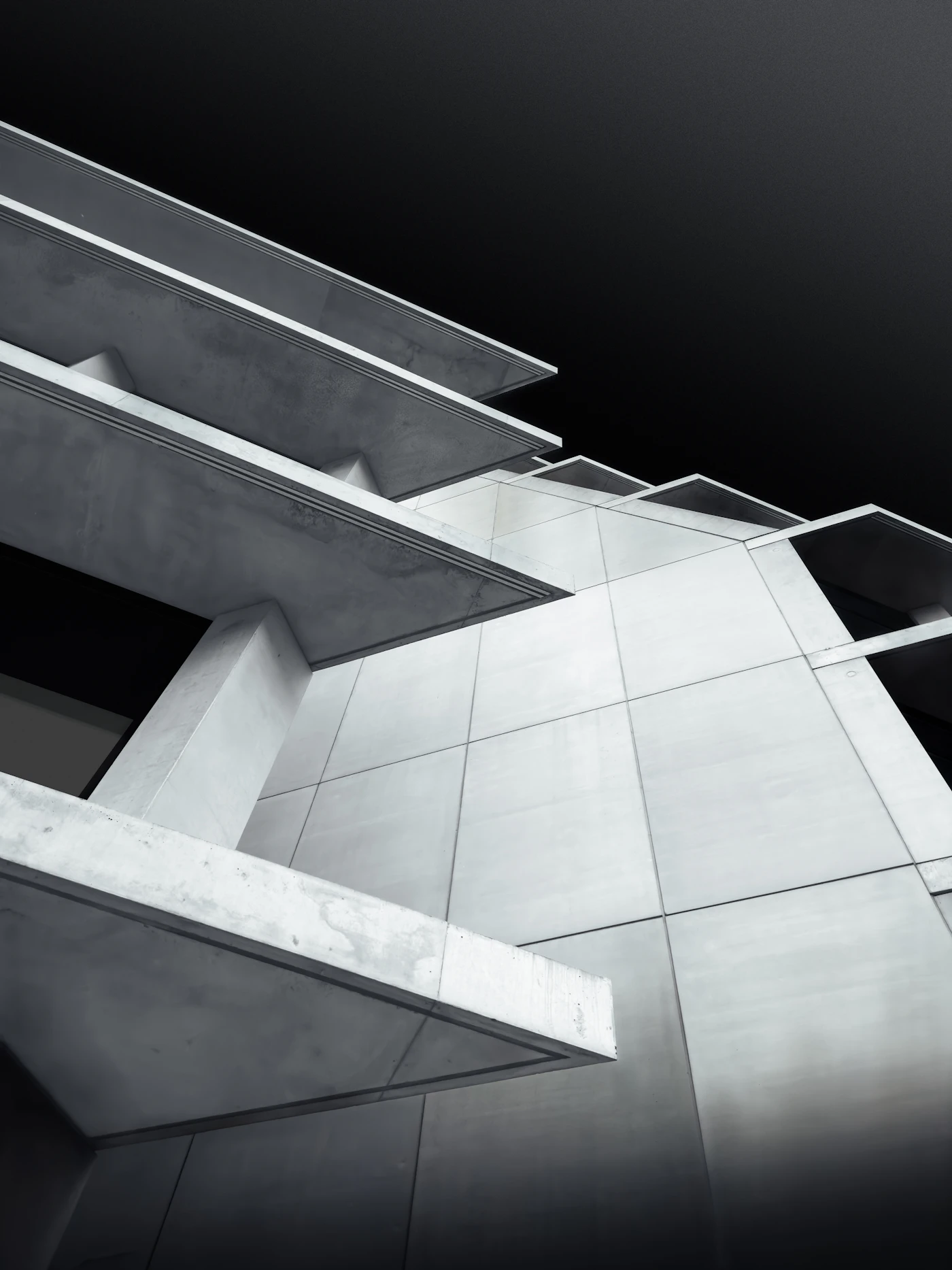 Cantilevered concrete balconies against a dark sky