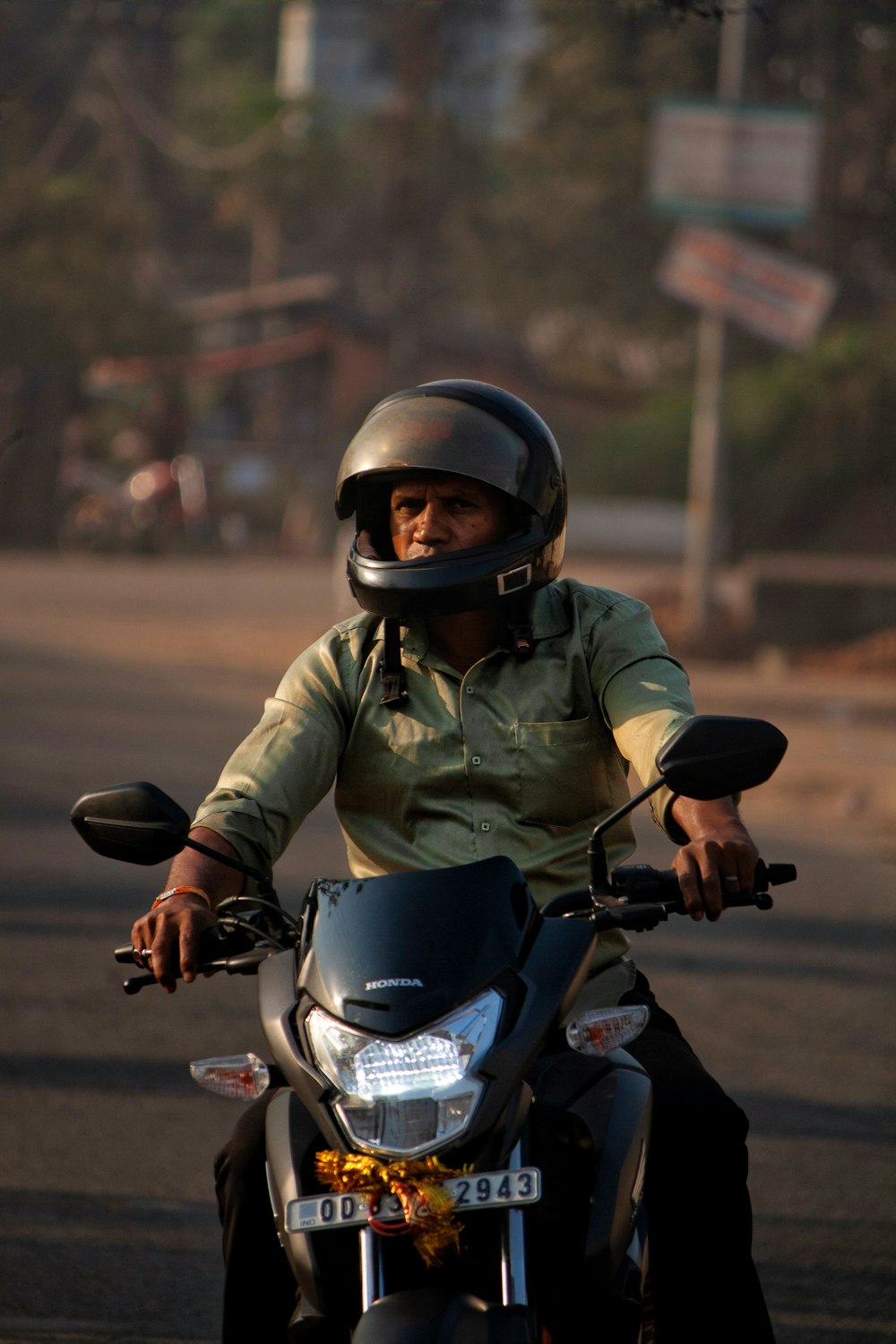 a man riding a motorcycle down a street