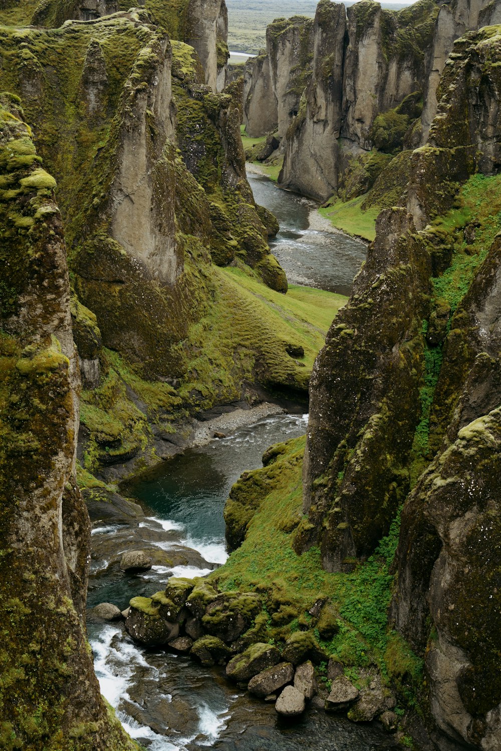 a river running through a lush green valley