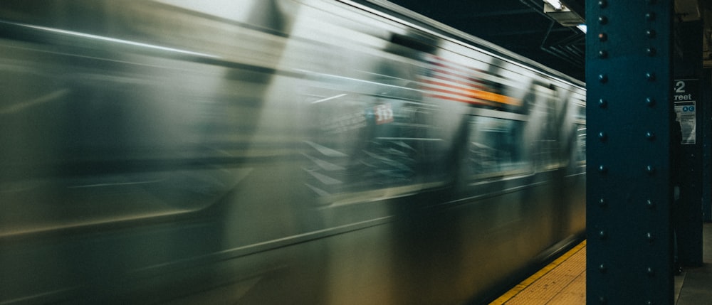 a blurry photo of a subway train speeding by