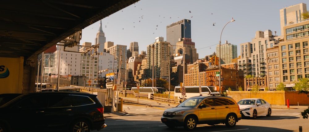 a city street filled with traffic next to tall buildings